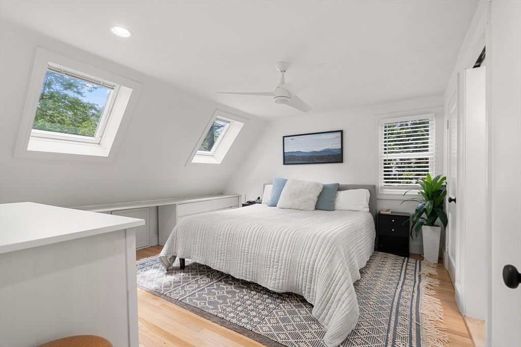 145 Pond Brook Road Newton, MA 02467 - Photo 24 of 39 a bedroom with a large bed and a potted plant
