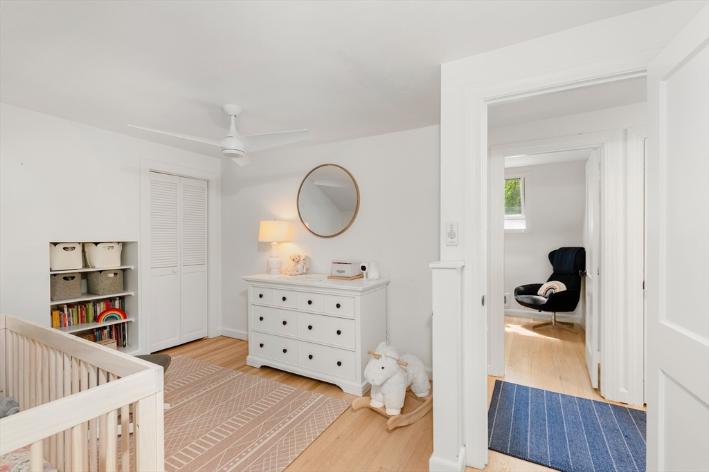 145 Pond Brook Road Newton, MA 02467 - Photo 27 of 39 a bedroom with furniture and a wooden floor