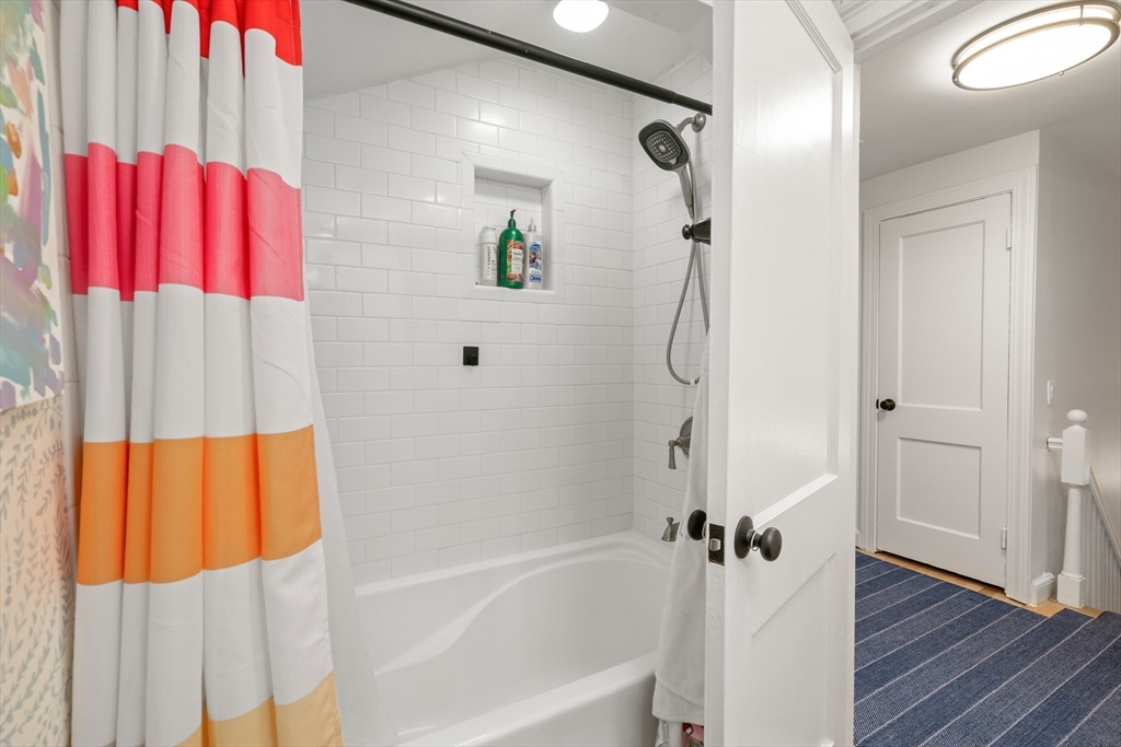 145 Pond Brook Road Newton, MA 02467 - Photo 30 of 39 a bathroom with a bathtub and a shower