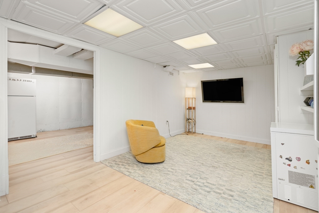145 Pond Brook Road Newton, MA 02467 - Photo 33 of 39 a view of a livingroom with an empty space and a flat screen tv