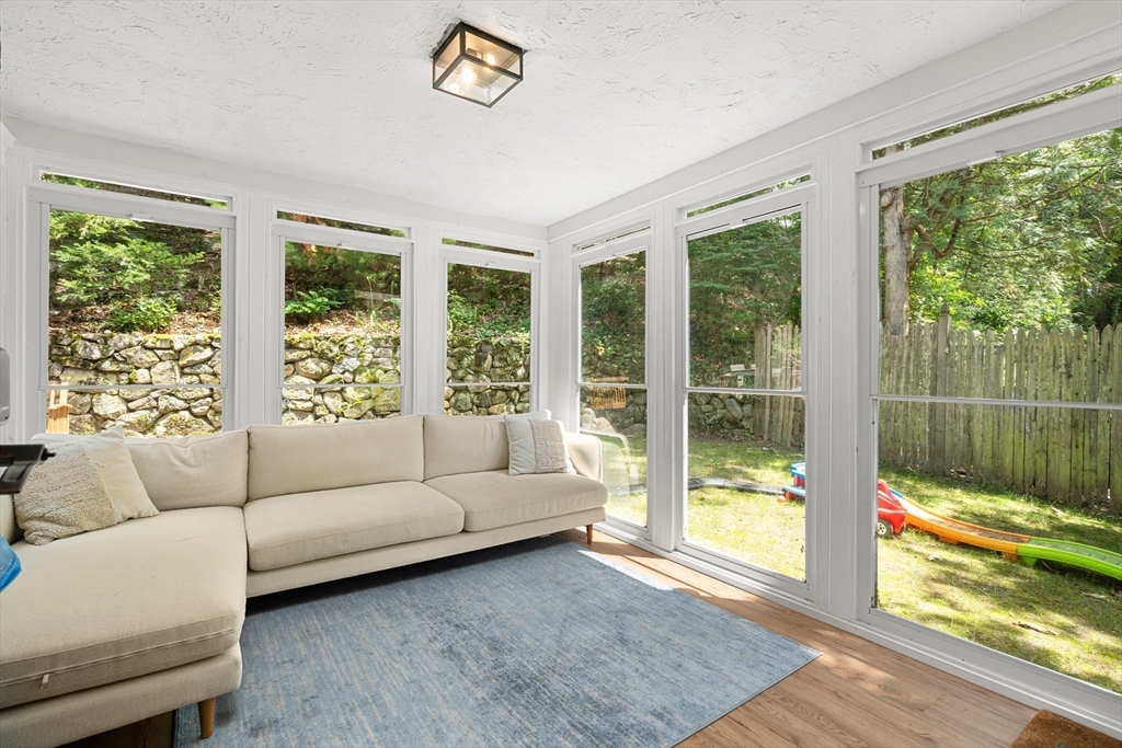 145 Pond Brook Road Newton, MA 02467 - Photo 35 of 39 a living room with furniture and a floor to ceiling window