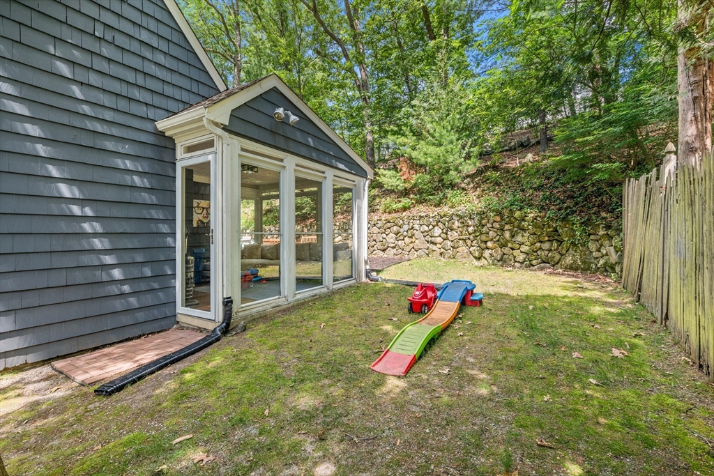 145 Pond Brook Road Newton, MA 02467 - Photo 36 of 39 a view of a lounge chair in the backyard of the house