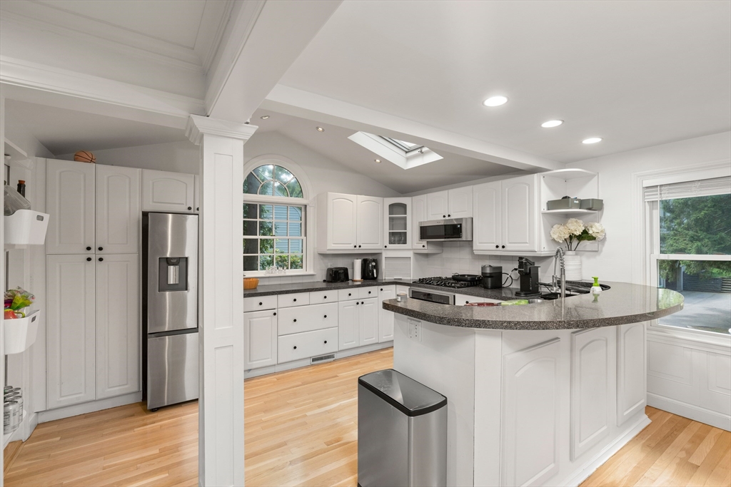 145 Pond Brook Road Newton, MA 02467 - Photo 8 of 39 a kitchen with stainless steel appliances granite countertop a sink stove and refrigerator