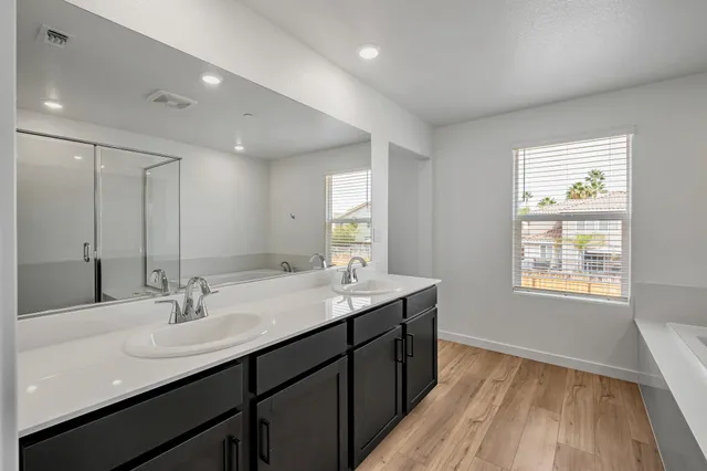 a bathroom with a sink double vanity and a mirror
