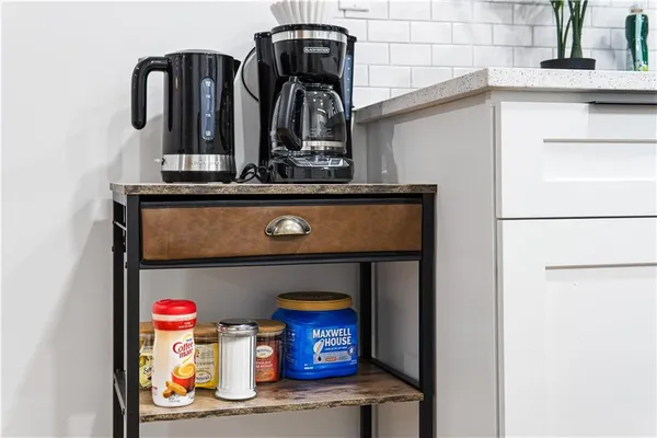 a kitchen that has a sink a stove and wooden floor