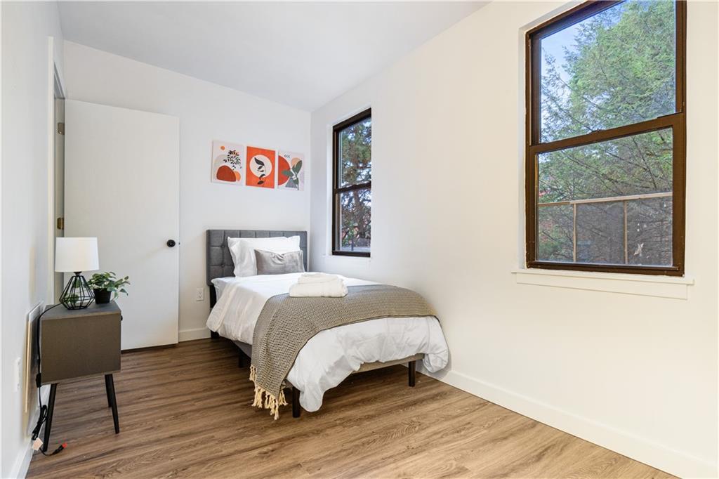 523 Alpine Avenue Pittsburgh, PA 15212 - Photo 23 of 29 a bedroom with a bed and wooden floor