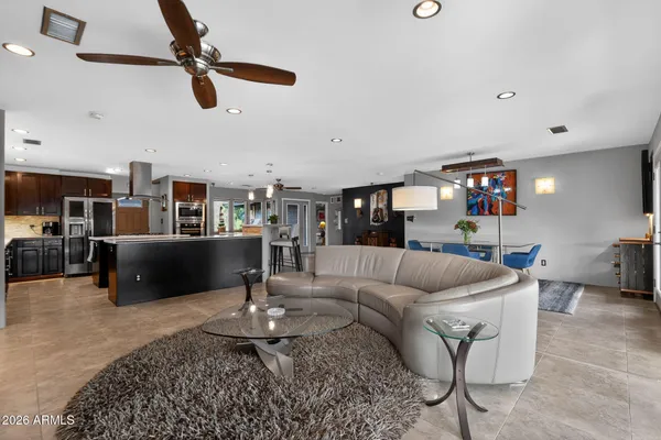 a living room with furniture and a ceiling fan