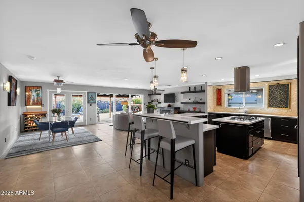 a kitchen with a table chairs stove and cabinets