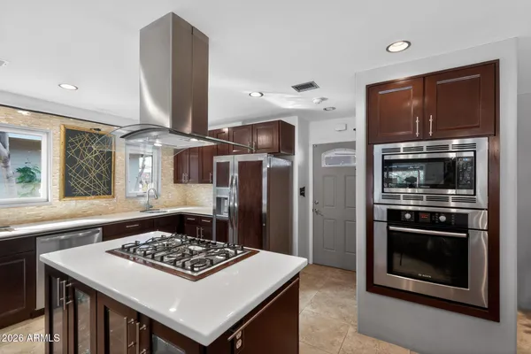 a kitchen with a stove and a refrigerator