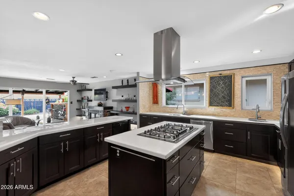 a kitchen with a sink a stove and a wooden cabinets