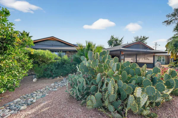 a view of a house with a yard and plants