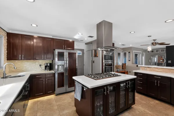 a kitchen with stainless steel appliances granite countertop a sink stove and refrigerator