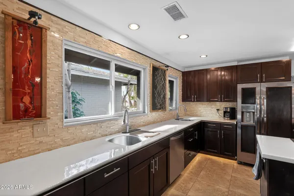 a kitchen with granite countertop a sink and cabinets