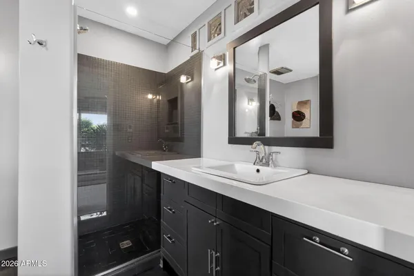 a bathroom with a double vanity sink and mirror