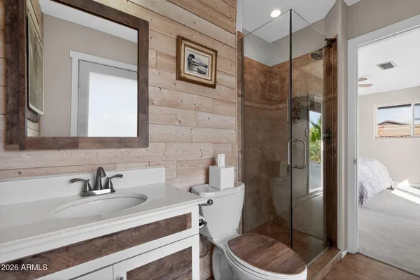 a bathroom with a sink a toilet and shower