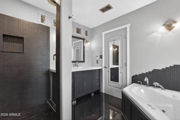 a en suite bathroom with a sink a toilet a shower and mirror