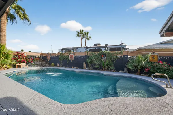 a view of a swimming pool with a outdoor seating and a yard