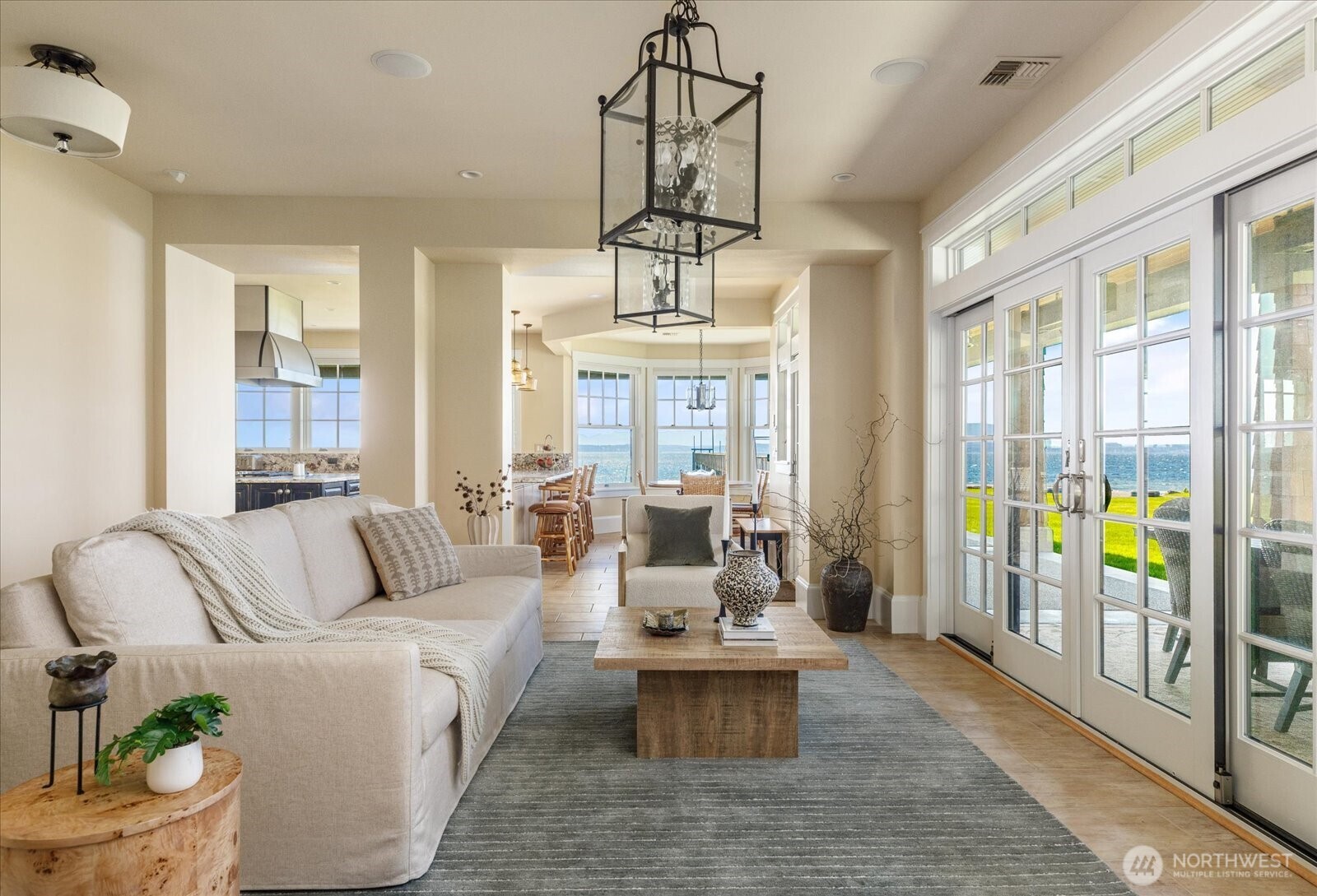 5848 Mutiny Bay Road Freeland, WA 98249 - Photo 19 of 40 a living room with fireplace furniture and a chandelier