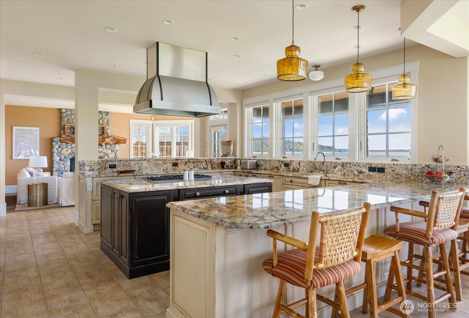 5848 Mutiny Bay Road Freeland, WA 98249 - Photo 22 of 40 a kitchen with a stove a sink a dining table and chairs