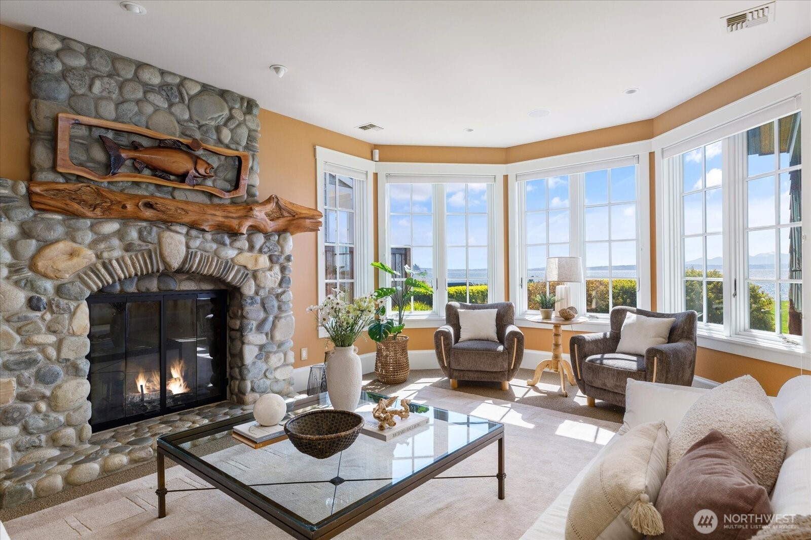 5848 Mutiny Bay Road Freeland, WA 98249 - Photo 27 of 40 a living room with furniture a large window and a fireplace