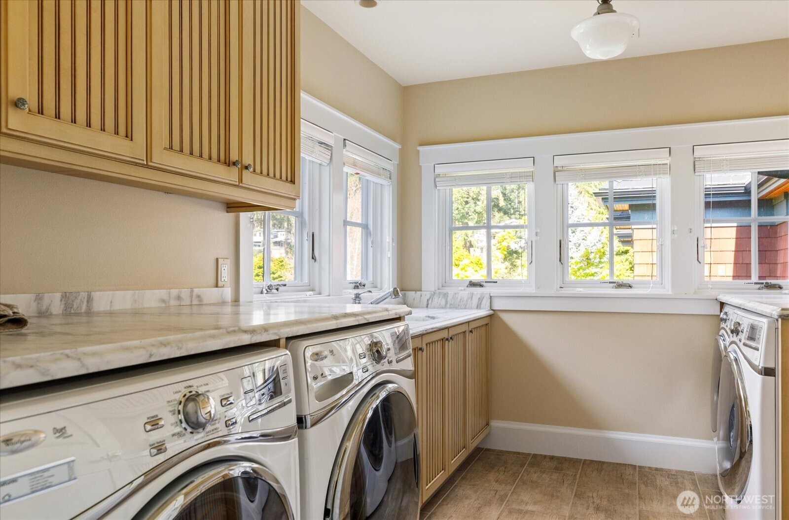 5848 Mutiny Bay Road Freeland, WA 98249 - Photo 33 of 40 a utility room with stainless steel appliances granite countertop a sink and a window