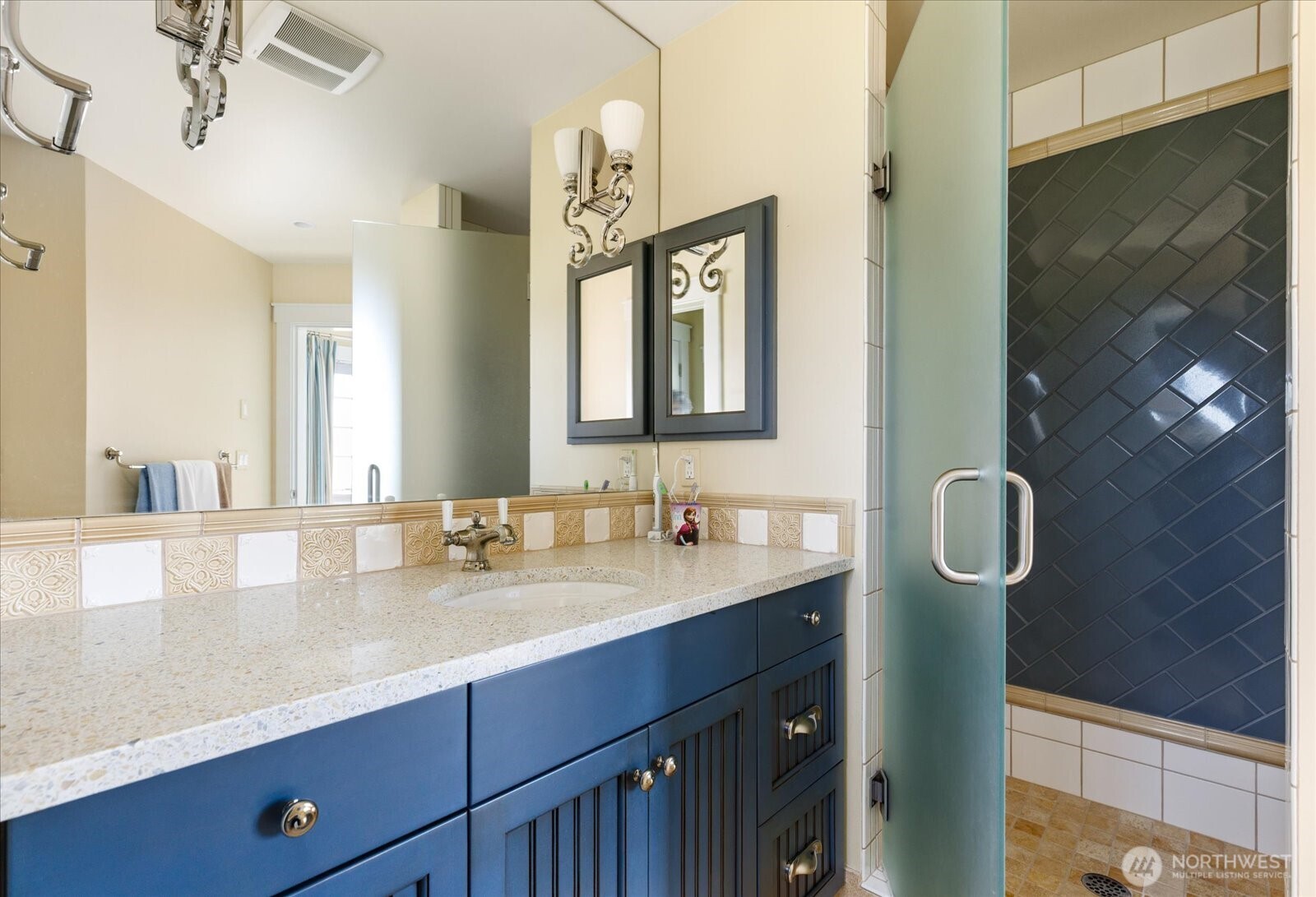 5848 Mutiny Bay Road Freeland, WA 98249 - Photo 37 of 40 a bathroom with a granite countertop sink a mirror and a shower