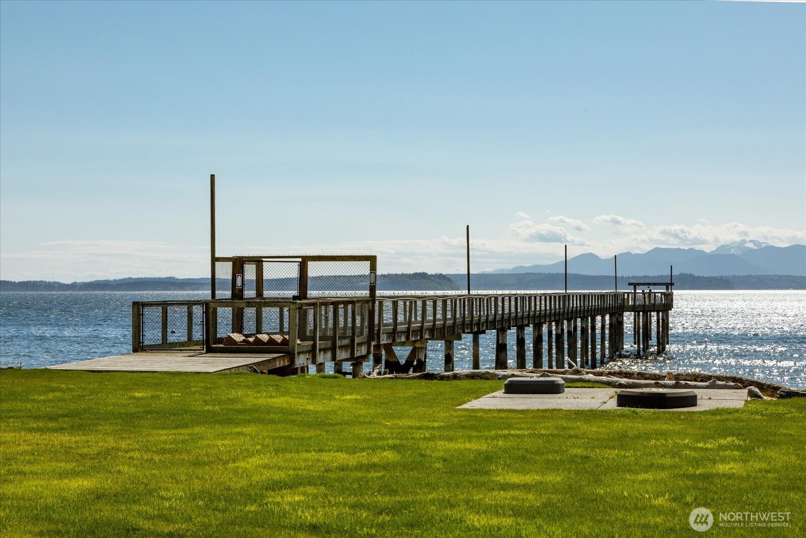 5848 Mutiny Bay Road Freeland, WA 98249 - Photo 7 of 40 a view of a swimming pool with a garden and lake view