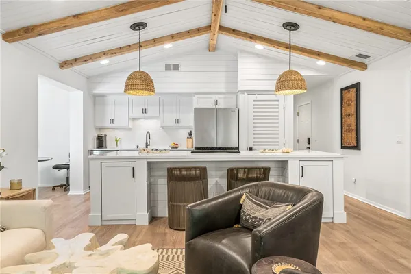 a living room with furniture and a ceiling fan