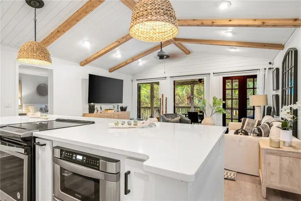 a view of kitchen with sink microwave and refrigerator