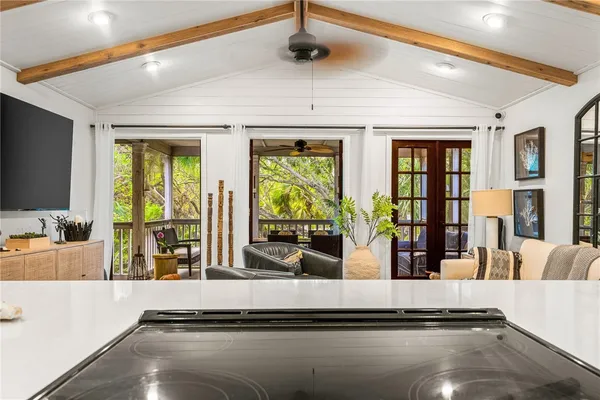 a view of living room with furniture and large windows