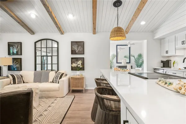 a living room with furniture and a chandelier