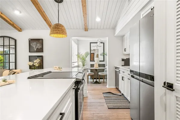 a kitchen with stainless steel appliances granite countertop a sink a stove and a refrigerator