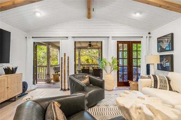 a bedroom with furniture and large windows