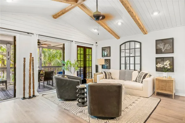a living room with furniture and large windows