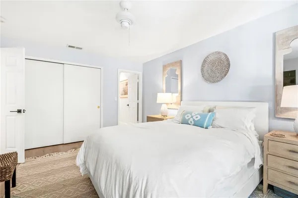 a bedroom with a bed and painting on the wall