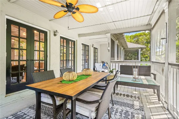 a living room with a table chairs and a table