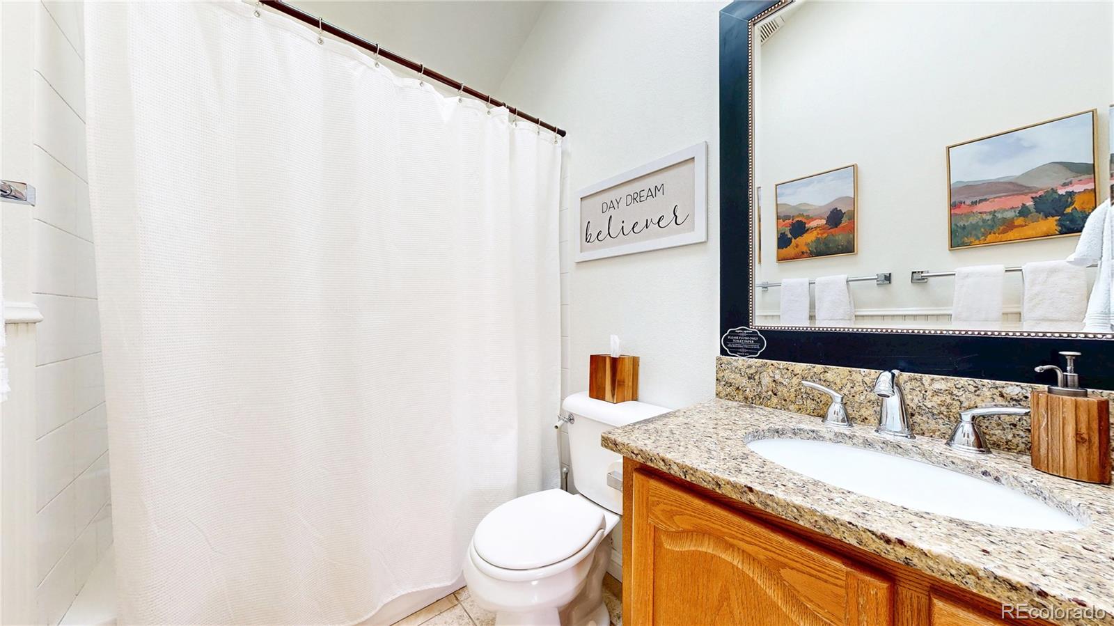 225 Rd P62 Bailey, CO 80421 - Photo 15 of 49 a bathroom with a granite countertop sink mirror vanity and toilet