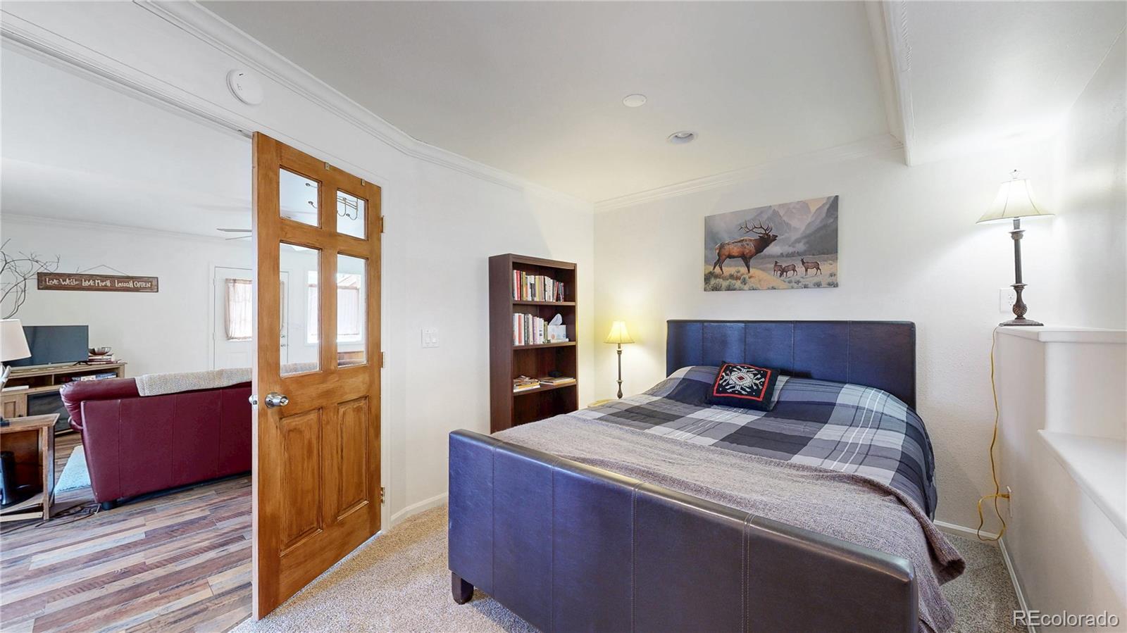 225 Rd P62 Bailey, CO 80421 - Photo 19 of 49 a bedroom with a bed and a painting on the wall