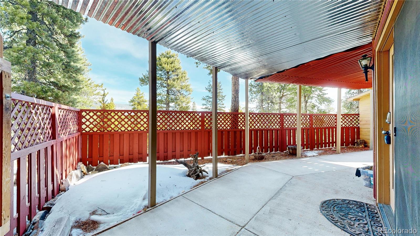 225 Rd P62 Bailey, CO 80421 - Photo 39 of 49 a view of a backyard with a large tree and wooden fence
