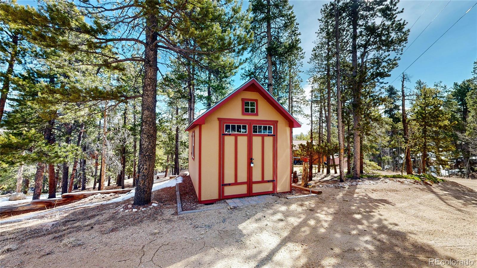 225 Rd P62 Bailey, CO 80421 - Photo 44 of 49 a front view of a house with a yard and garage