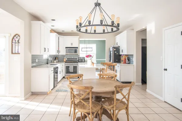 a dining room with furniture and a chandelier