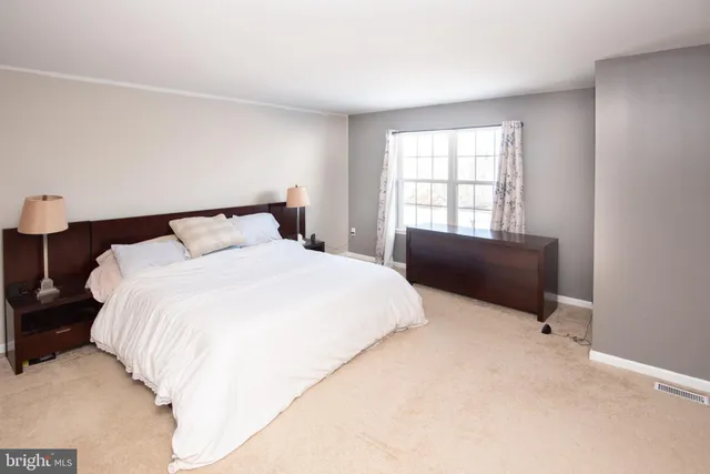 a bedroom with a bed and a table