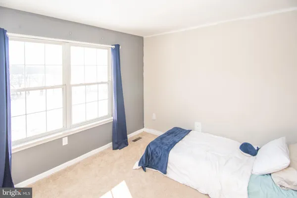 a view of staircase with lots of frames on wall and a window