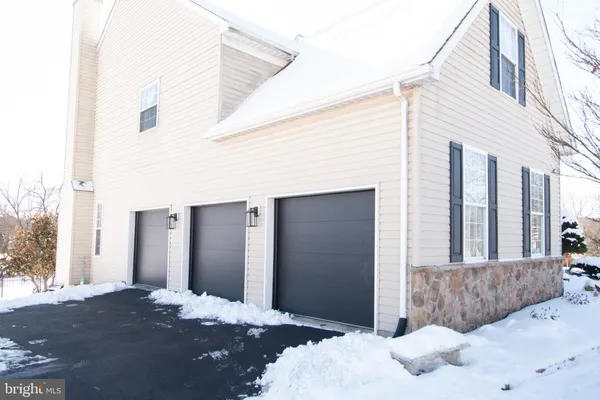 a living room with furniture a fireplace and a large window