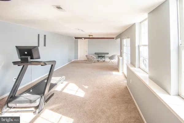 a view of a big building with a big yard and plants