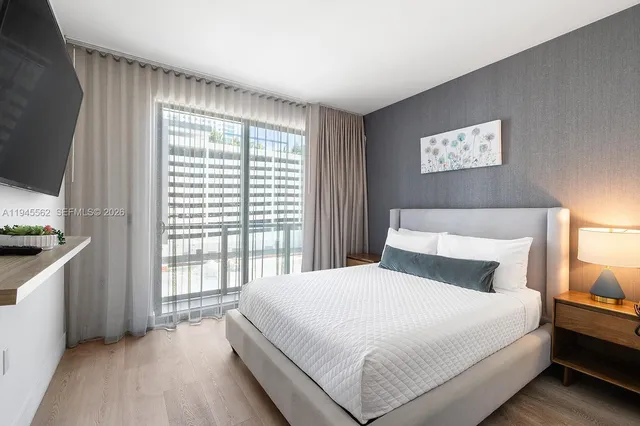 a bedroom with a large bed and a window