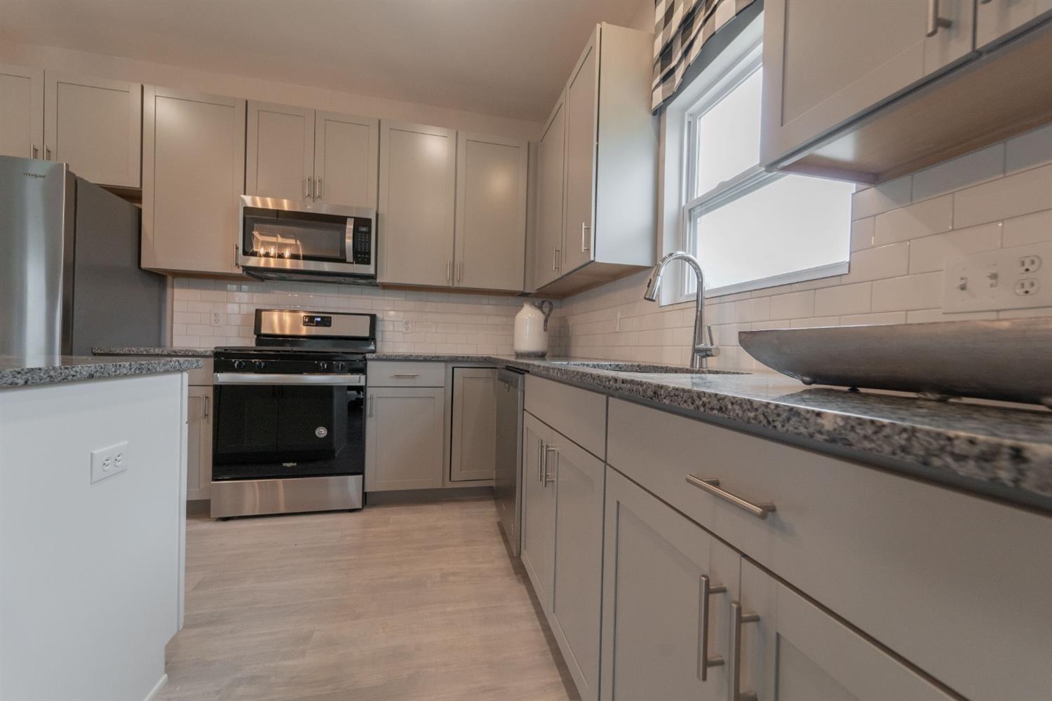 8665 Burr Rdg Circle Crown Point, IN 46307 - Photo 11 of 21 a kitchen with stainless steel appliances granite countertop a sink stove and refrigerator