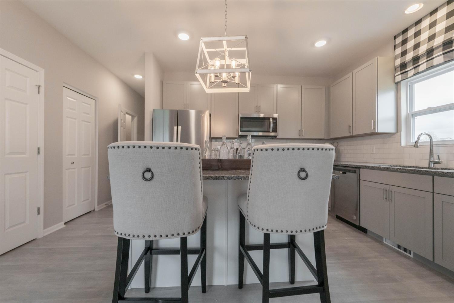 8665 Burr Rdg Circle Crown Point, IN 46307 - Photo 8 of 21 a kitchen with stainless steel appliances a white table chairs and a refrigerator