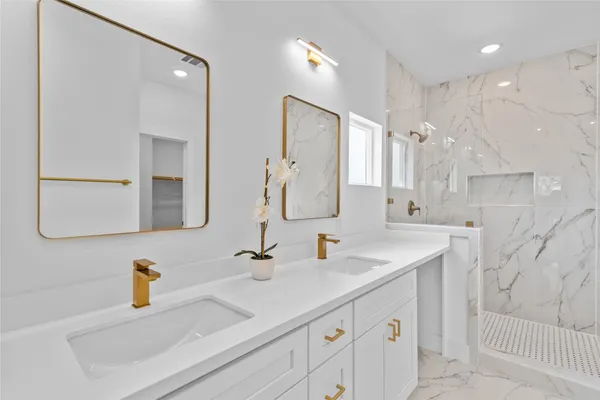 a bathroom with a sink double vanity and a mirror