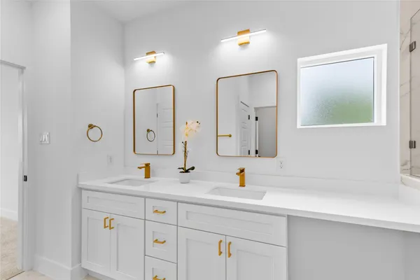 a bathroom with a double vanity sink mirror and